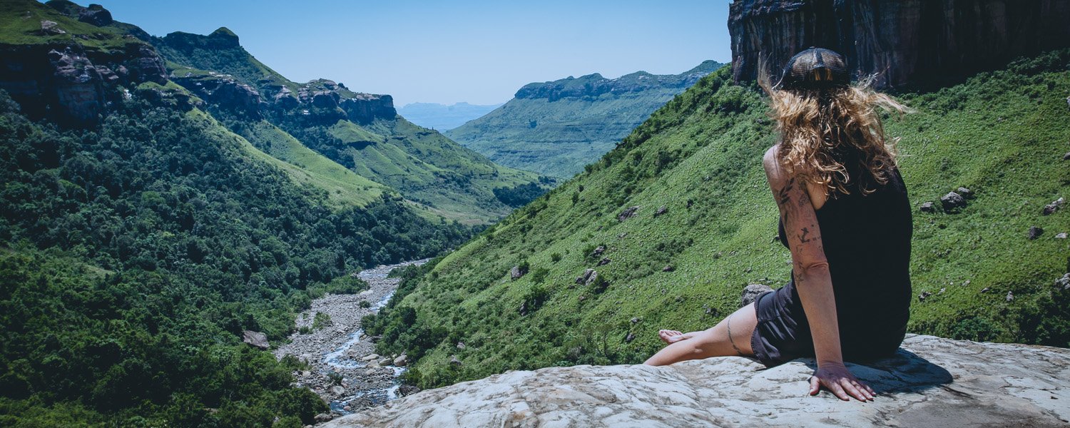 Female hiker looking down onto the river below