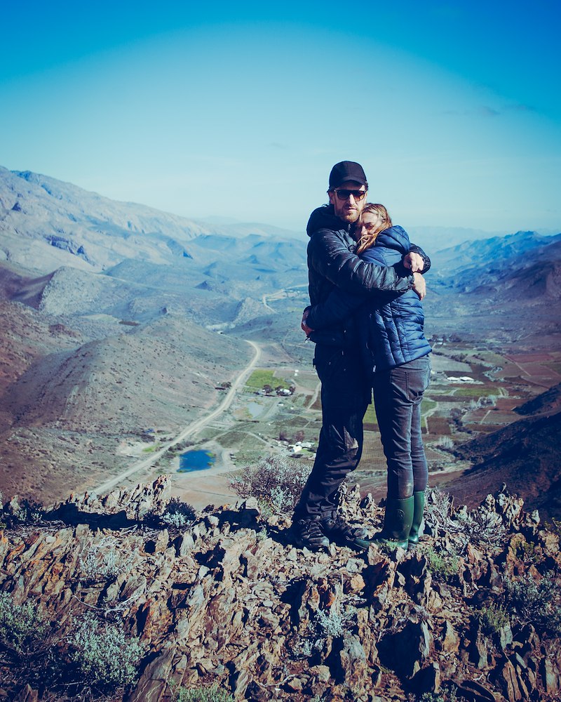 Hikers on top of a mountain with a beautiful view