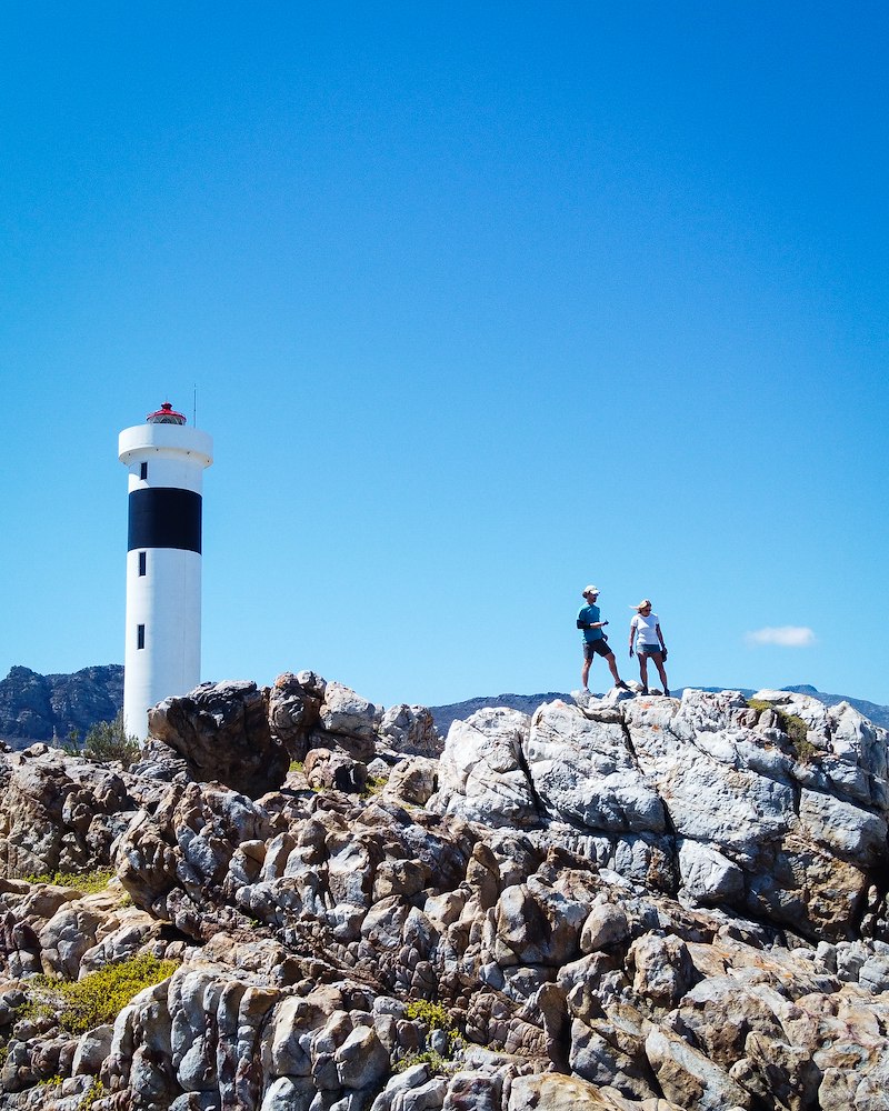 Couple standing near a lighthouse