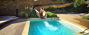 Woman enjoying a slide into a pool