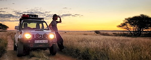 Enjoying the late afternoon sunset while leaning on vehicle