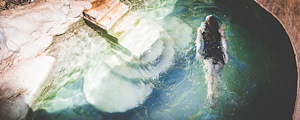 Woman swimming in hot spring at Riemvasmaak